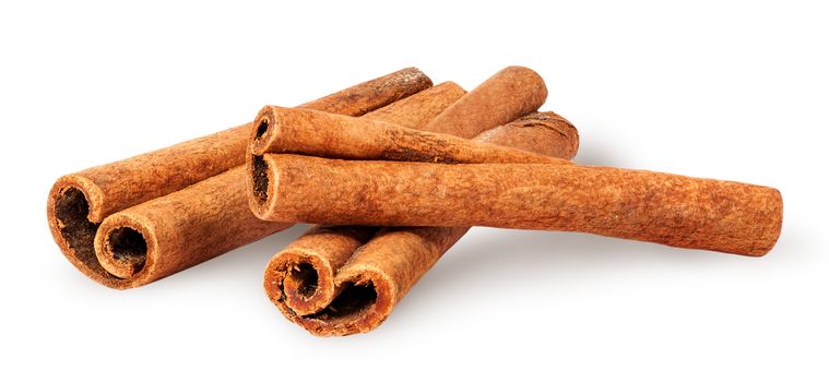 Three cinnamon sticks lying cross isolated on white background