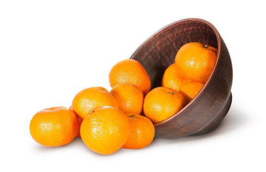 Tangerines Spill Out Of Clay Bowl Isolated On White Background