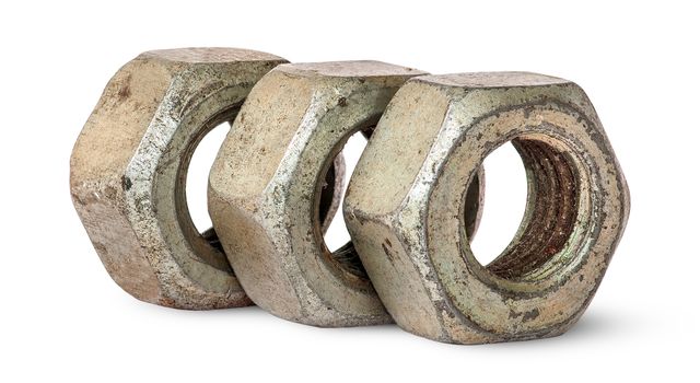 Three old rusty nuts in a row rotated isolated on white background