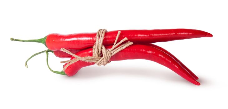 Three red chili peppers tied with a rope reversed isolated on white background