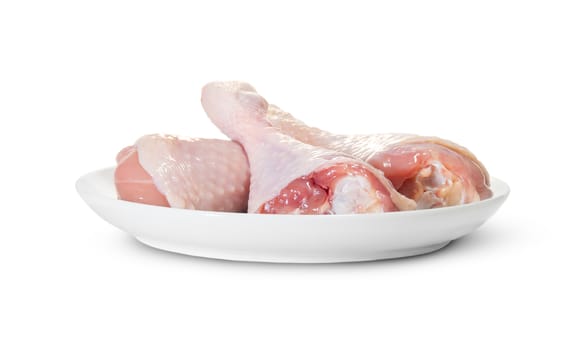 Three Raw Chicken Legs On White Plate Rotated Isolated On White Background