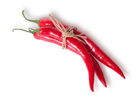 Three red chili peppers tied with a rope top view isolated on white background