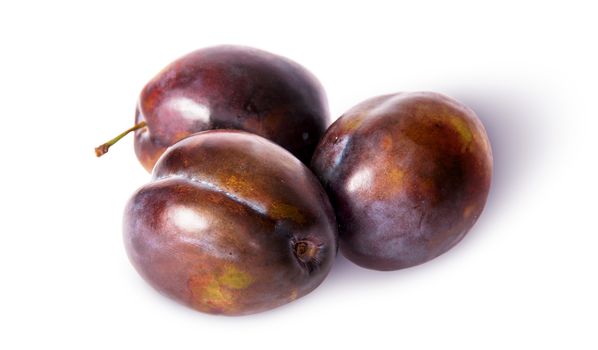 Three violet plums isolated on white background