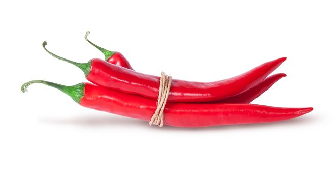 Three red chili peppers tied with a rope isolated on white background