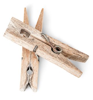 Two old wooden clothespins on each other isolated on white background