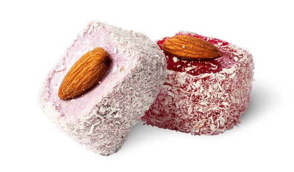 Two pieces of Turkish Delight with almonds isolated on white background