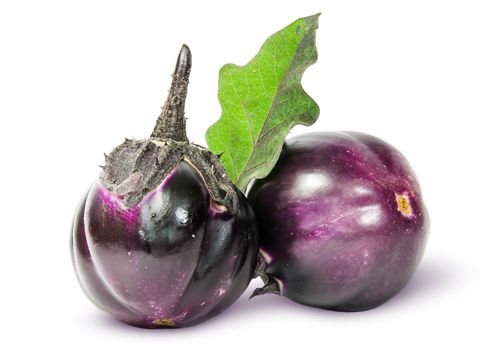 Two round ripe eggplant with green leaf isolated on white background