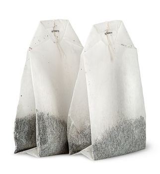 Two tea bags each other isolated on white background