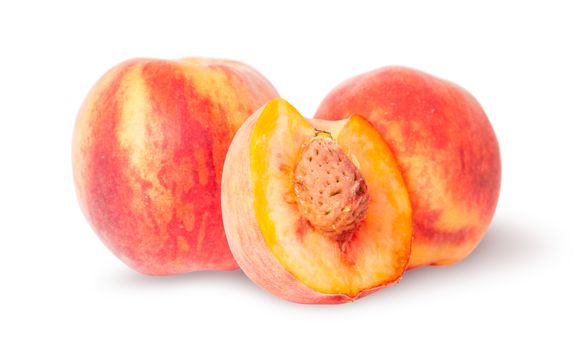 Two whole and half of peach isolated on white background