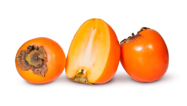 Two Whole And One Half Persimmons Isolated On White Background