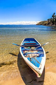 Lone boat, blue water and coast of Titicaca, Island of the Sun, Bolivia, south America