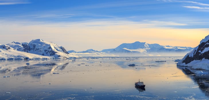 Neco bay surrounded by glaciers and cruise vessel drifting slowly, Antarctic