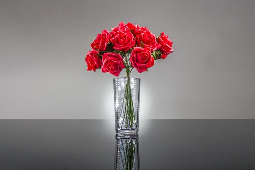  Red roses over a glossy surface