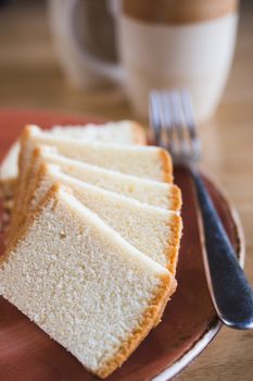 madeira cake on plate with a cup of tea, butter sponge cake