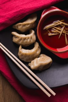 fried pork dumplings with a soy sauce and chopsticks