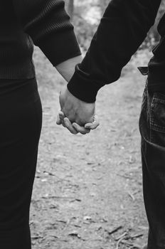 couple standing holding hands outdoors