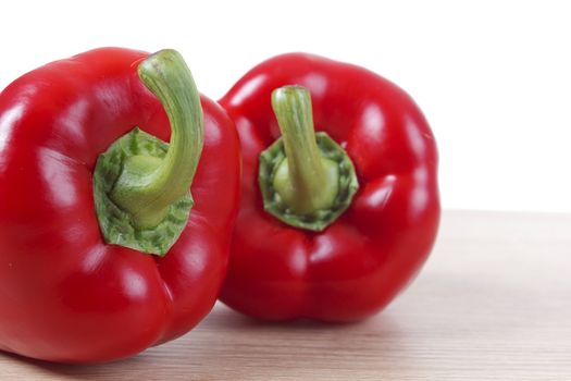 Ripe red peppers closeup on white background