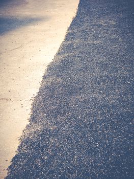 Close up asphalt road repair. Repair pavement and laying new asphalt patching method outdoors.