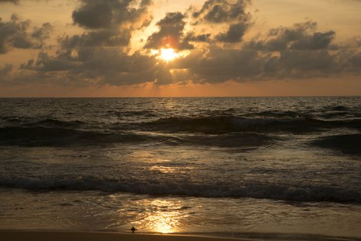 a beautiful sunset in the sea on the beach