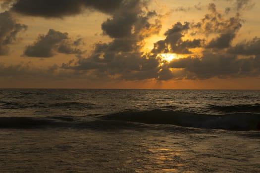 a beautiful sunset in the sea on the beach