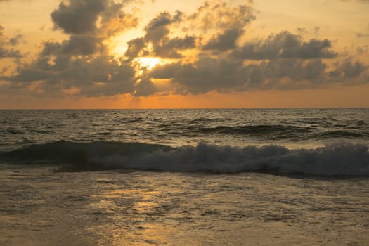 a beautiful sunset in the sea on the beach