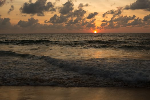 a beautiful sunset in the sea on the beach