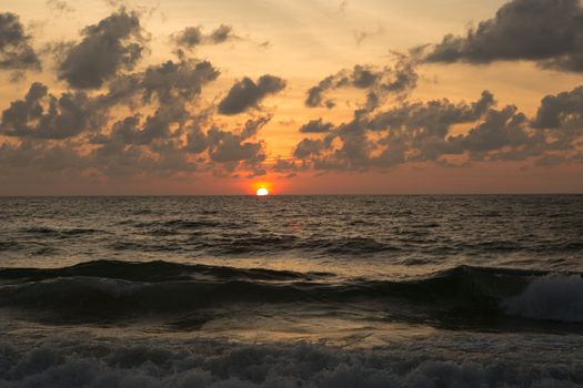 a beautiful sunset in the sea on the beach