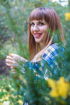 portrait of a beautiful, dreamy girl with long straight hair in a blue long dress in the park in autumn