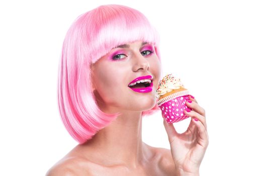 Portrait of girl with glamour make-up and pink hair ready to eat a cake isolated on white background