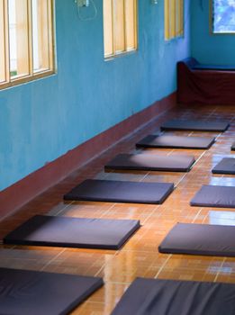 COLOR PHOTO OF ARRANGED MEDITATION CUSHIONS IN MEDITATION CENTER