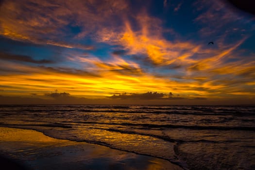 The sun rises at the beach on a cloudy morning over Amelia Island, Florida.