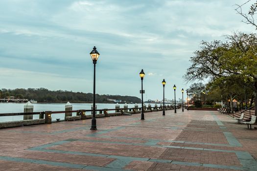 Lamplight illuminates the morning on River Street in Savannah, Georgia.