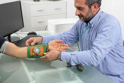 Doctor and patient with blood pressure meter in Doctor's office.