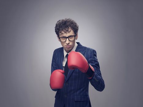 Businessman in boxing gloves ready to fight