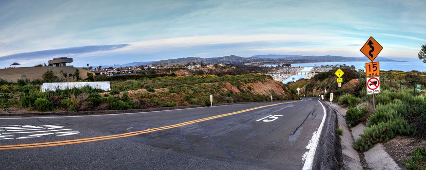 Road leading down to Dana Point Harbor at sunset in Southern California, USA