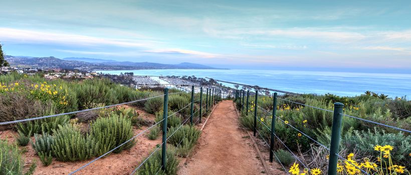 Hiking trail above Dana Point city view at sunset in Southern California, USA