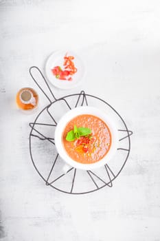 Bowl of Fresh tomato soup Gazpacho on a white background.