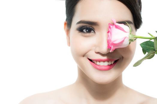 Copy-spaced portrait of a beautiful lady with a rose flower over a white background. Woman day concept. Closeup fresh face girl.