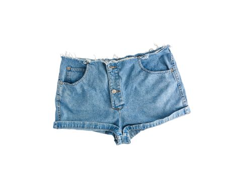Denim short shorts with torn edge, isolated on white background.