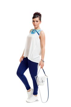 the young woman in convenient clothes with a bag on a white background