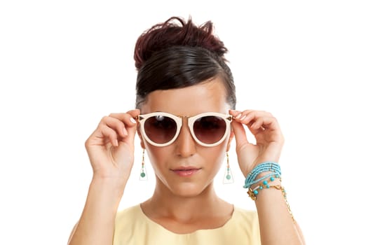the young woman in sunglasses on a white background