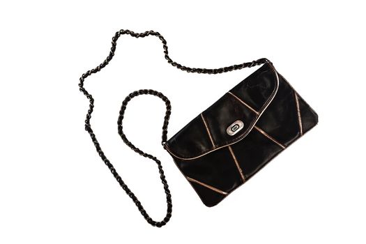 Female clutch bag on a long handle-chain, isolated on a white background.