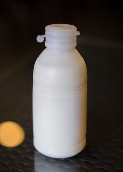 COLOR PHOTO OF PLASTIC BOTTLE OF WHITE MILK