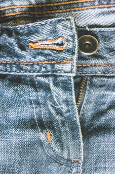 Denim pants to unfasten the zipper close-up.