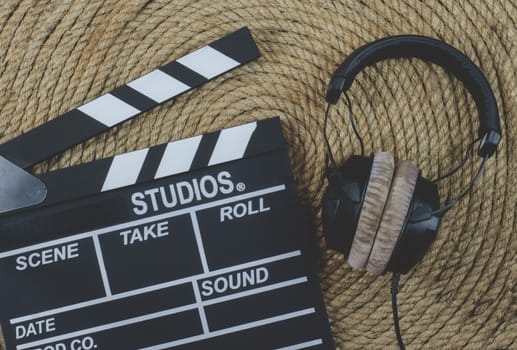 Slate film and headphone  on a jute rope background
