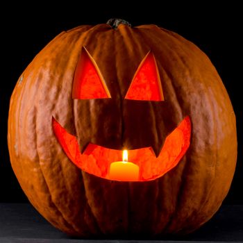 Funny glowing Halloween pumpkin isolated on a black background