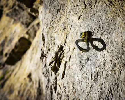 Dreamy background Anchor climbing on a rock wall