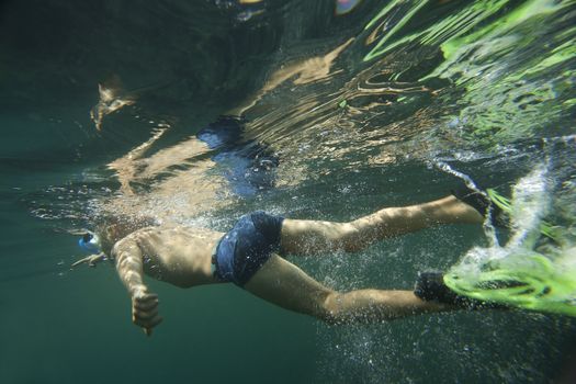 A swimmer underwater in the Black Sea in flippers and snorkel.
