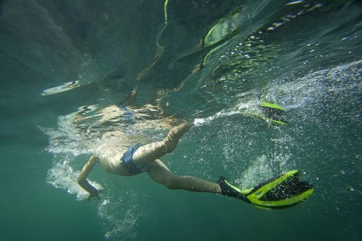 A swimmer underwater in the Black Sea in flippers and snorkel.