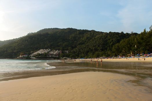 a white sand beach with mountain and trees on background, Phuket Island in Thailand